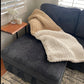 Medium multi-toned blanket in Ivory and Taupe draped over a couch