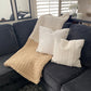 Medium multi-toned chunky knit blanket in Ivory and Taupe draped over a couch